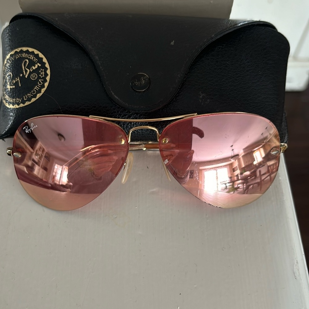 Woman’s pink Ray Ban aviator sunglasses